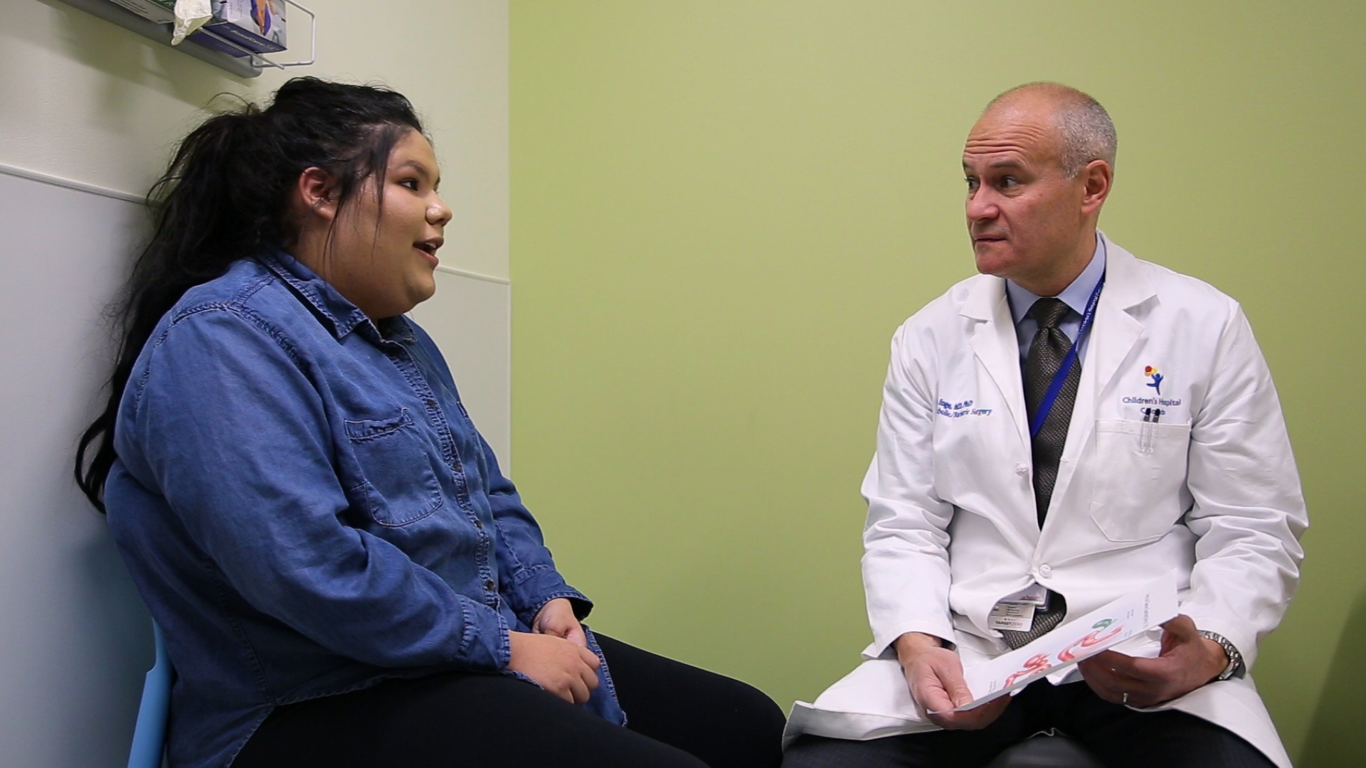 Dr. Thomas Inge is in the bariatric surgery clinic speaking to an adolescent patient.