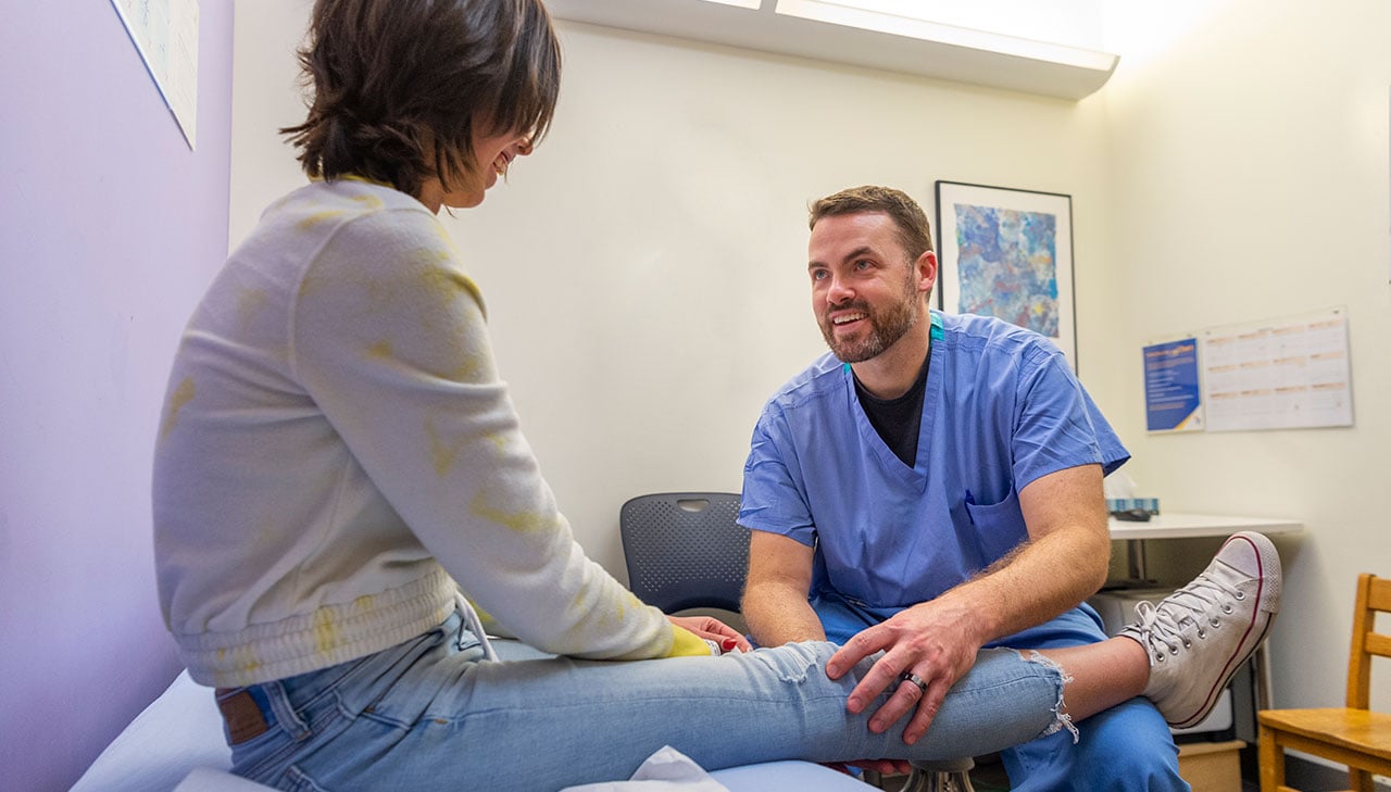 Dr. Nathan Donaldson with a patient who had a total joint replacement.