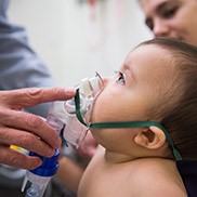 An infant receives oxygen in the Breathing Institute